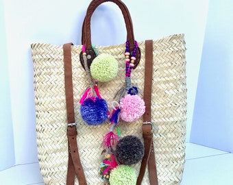 Straw backpack with pom poms