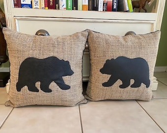 Pair of black bear pillows with subtle black piping surrounding beautiful brown and black heavy upholstery material measuring 15x15 each