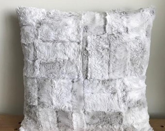 Handmade Faux fur pillow. Measures 18" x 18".  Super soft snow Leopard print on front and dark brown wavy faux fur on backside.