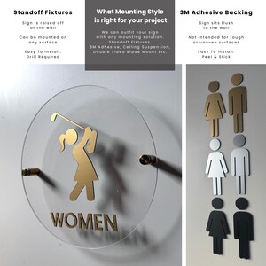 K&ouml;nnte beinhalten: Ein rundes Schild aus klarem Acryl mit einer goldenen Grafik einer Person, die einen Golfschl&auml;ger schwingt, und dem Text WOMEN. Das Schild ist mit goldenen Abstandshaltern montiert. Rechts befinden sich sechs Strichm&auml;nnchen in Gold, Silber und Schwarz.