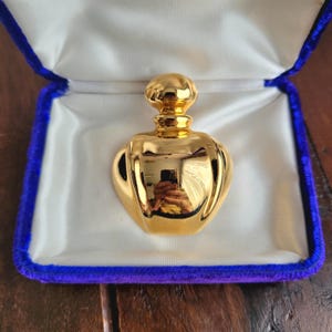 Vintage gold tone Christian Dior perfume bottle. Gift idea. Unsigned.
