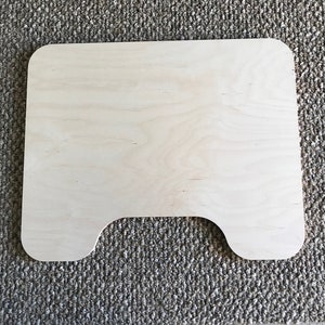 May include: A plain, unfinished, light wood cutout of a rectangle with two rounded cutouts at the bottom.