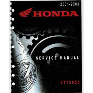 May include: A black and red Honda Service Manual for the VT750DC motorcycle, covering the years 2001-2003. The cover features the Honda logo, a motorcycle wheel graphic, and the words "SERVICE MANUAL".