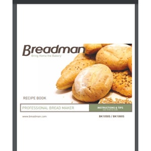 May include: A recipe book for a professional bread maker. The cover features a close-up of several loaves of freshly baked bread. The book is titled "Breadman" and includes the website address "www.breadman.com".