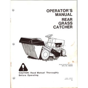 May include: An operator's manual for a rear grass catcher. The cover features a black and white illustration of a riding lawn mower with a grass catcher attached. The text reads "CAUTION: Read Manual Thoroughly Before Operating."