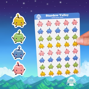 May include: A sheet of stickers featuring 36 adorable Junimo characters from the video game Stardew Valley. The Junimos are depicted in four different colors: yellow, green, blue, and pink. Each Junimo is holding a small apple and has a happy expression on its face. The sticker sheet is titled "Stardew Valley - Junimo sticker sheet -" and is made by Shark's Handmade.