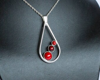 A handmade, sterling silver teardrop pendant, with three of our own kiln fired, vibrant red enamels. With a FREE chain and FREE UK postage!
