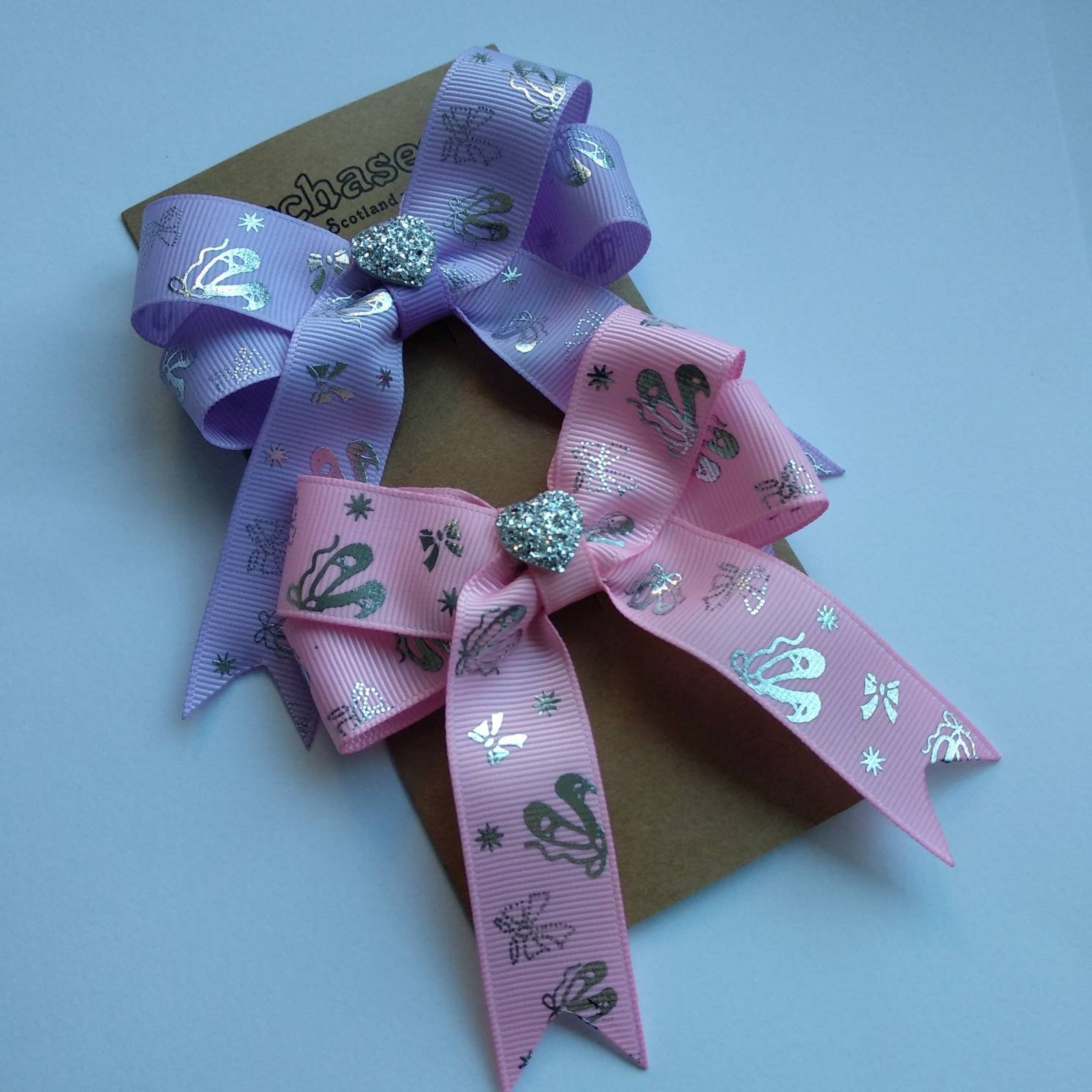 pack of 2 ballerina hair bows on clips or elastic, with silver ballet details and shiny heart centre. perfect gift for little da