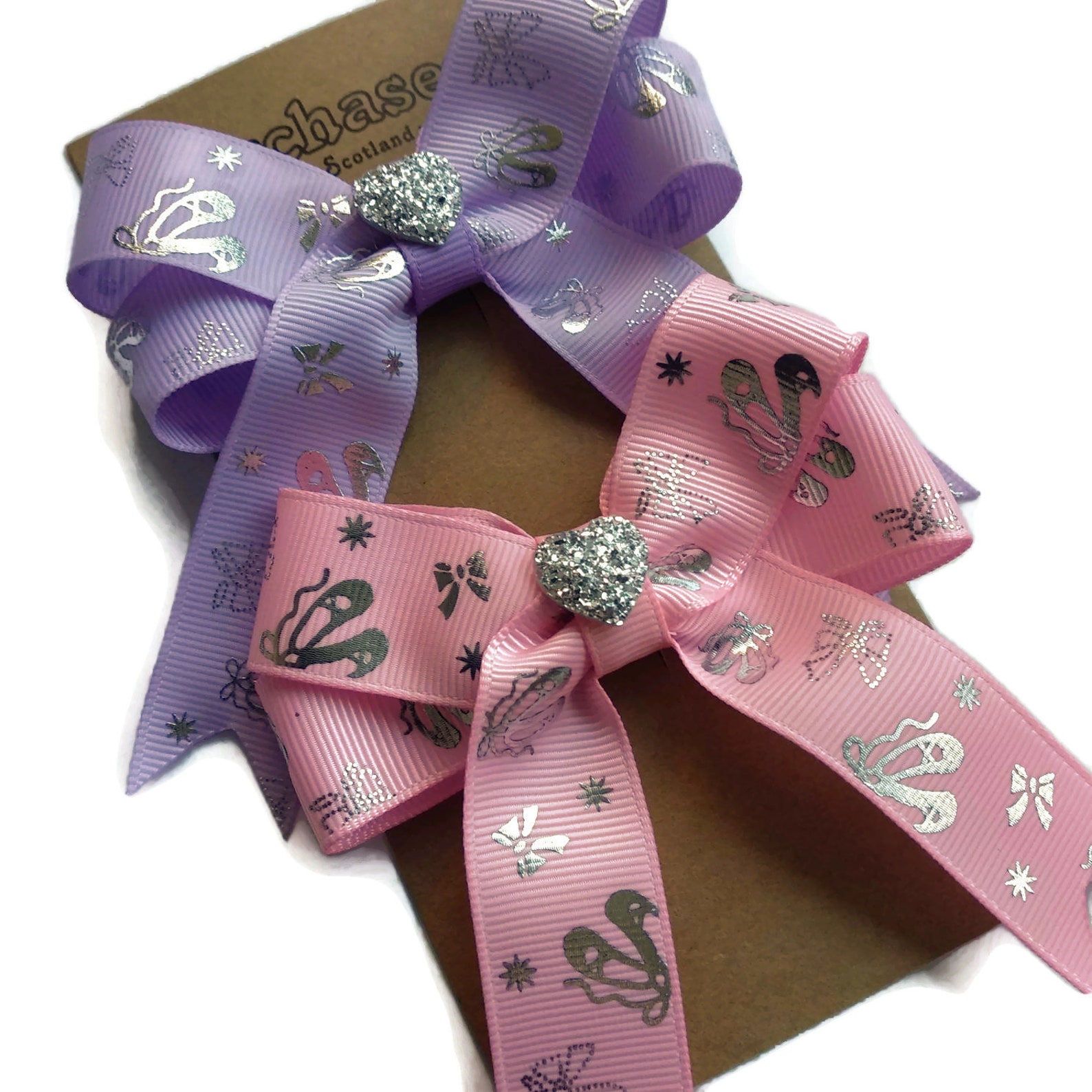 pack of 2 ballerina hair bows on clips or elastic, with silver ballet details and shiny heart centre. perfect gift for little da