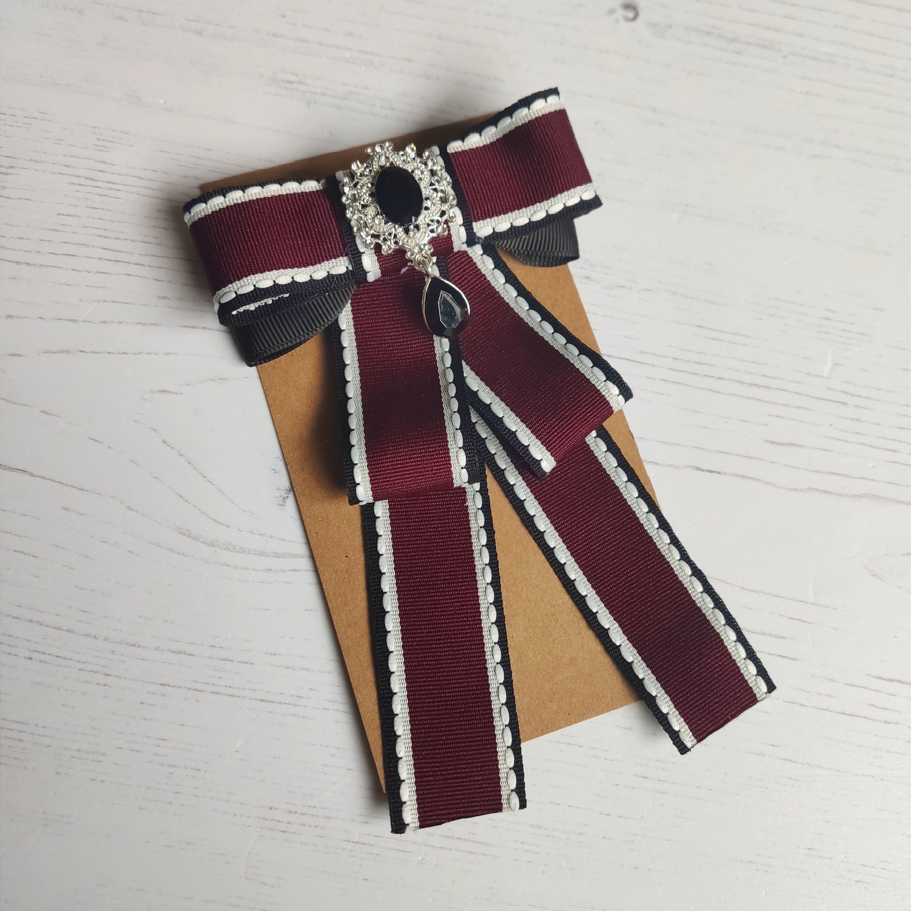 Gucci ribbon shop brooch