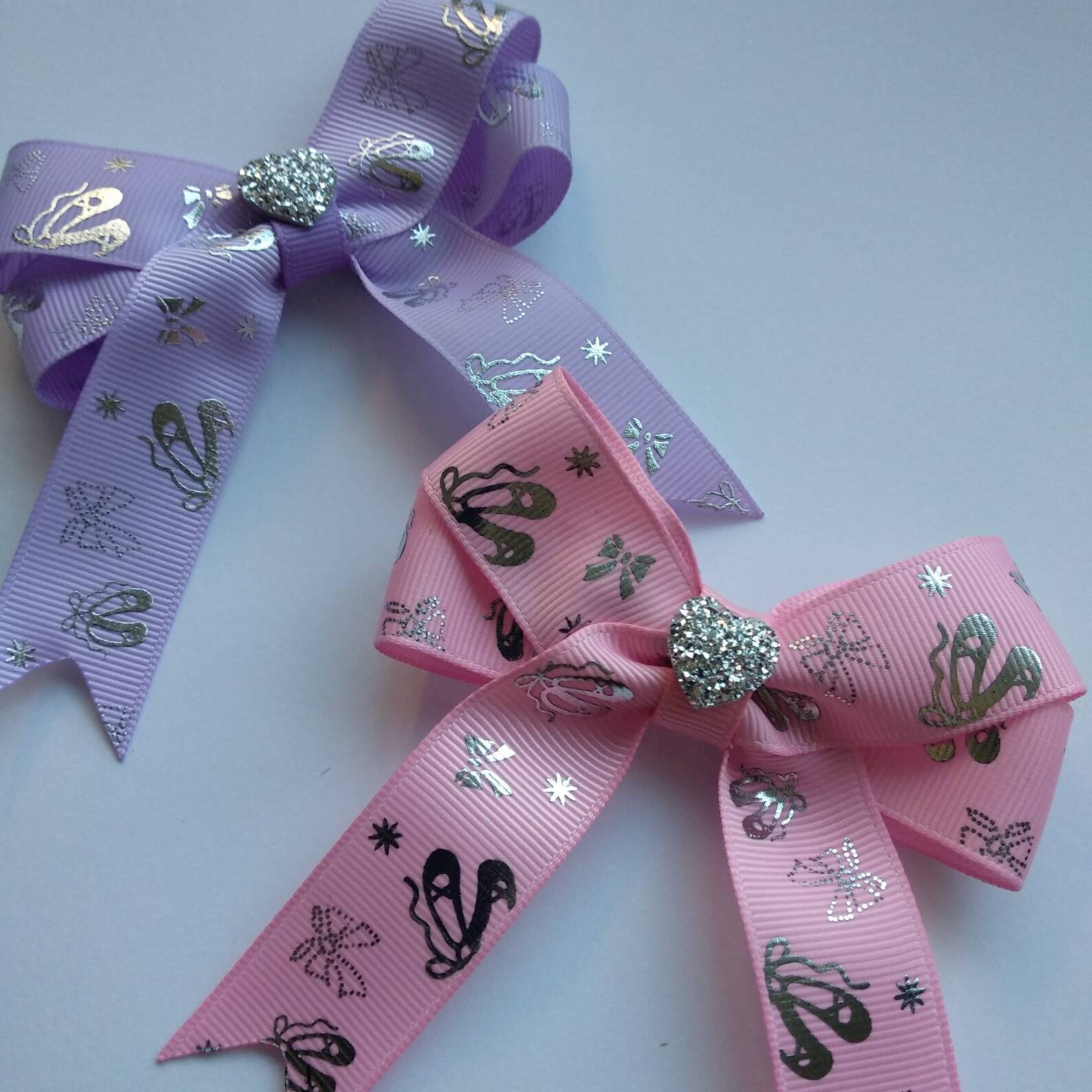 pack of 2 ballerina hair bows on clips or elastic, with silver ballet details and shiny heart centre. perfect gift for little da