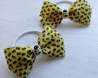 Bee Hair Bows on no snag elastic in a pack of 2. Lovely yellow bows that are perfect for ponytails.