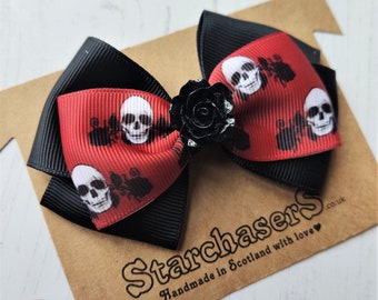 Gothic Skulls & Roses Hair Bow on Clip or Barrette. 8cm Bow in Black and Red with Skull Print and a Black rose Centre.