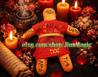 May include: A handmade voodoo doll with a red outfit and gold belt, surrounded by burning candles, flowers, and a scroll. The doll has an eye on its head and symbols on its body. The Etsy shop name is visible.
