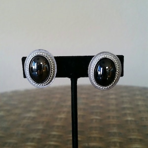 Vintage Gorgeous YSL Black Glass Oval Cabochon Adjustable Clip Earrings in a White Gold Plated Rope Design Setting.