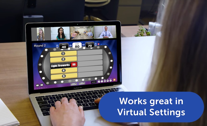May include: A laptop screen displaying a game show with a virtual audience, the game show is called "Light Fireworks" and the current round is round 2. The game show is being played on a laptop computer. The text "Works great in Virtual Settings" is displayed on a blue banner at the bottom of the image.