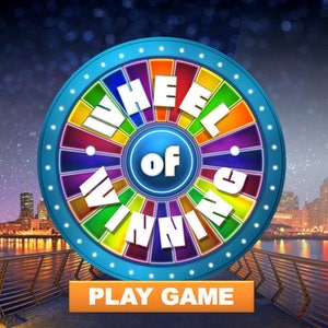 May include: A colorful wheel of fortune game with the text "Wheel of Winning" and a button that says "Play Game". The wheel is set against a backdrop of a city skyline at night.