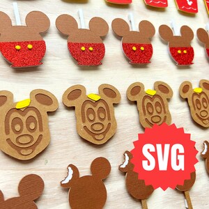 May include: A set of 12 printable SVG files featuring Mickey Mouse themed food items. The designs include Mickey Mouse shaped ice cream, apple, and cupcakes. The designs are perfect for creating party decorations or personalized gifts.