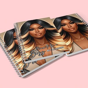 May include: Three spiral bound notebooks with a brown background and a black and blonde illustration of a woman. The text on the notebook reads "Born to be a Boss, Not be Bossed".