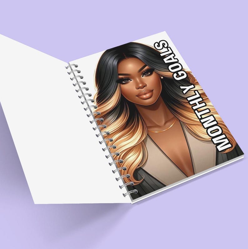 May include: A spiral bound notebook featuring a black and white illustration of a woman with long blonde and black hair. The cover of the notebook reads "MONTHLY GOALS" in white text.