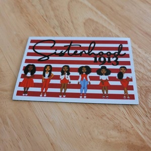 May include: A red and white striped background with the text "Sisterhood 1913" in black. Six black women are standing in a row, each wearing a red dress and white shoes.