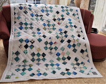 High-quality unique quilt made of designer quality fabrics, red, blue, green, etc., lovingly color coordinated, finely stitched