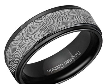 May include: A black tungsten carbide ring featuring a continuous, engraved silver-toned fingerprint pattern around the outer band. The interior of the ring is smooth, black, and clearly displays the laser-engraved text Tungsten Carbide.