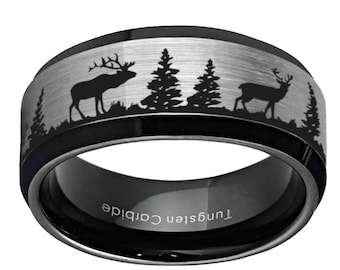 May include: Black tungsten carbide ring with a brushed silver band featuring a forest scene with deer silhouettes. The ring has a black inner band with the text "Tungsten Carbide".