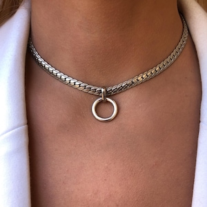 May include: A silver chain choker necklace with a silver ring pendant.