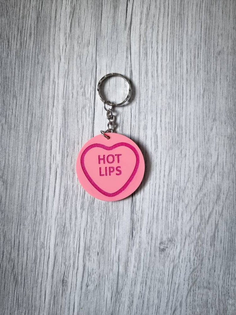 May include: Pink heart-shaped keychain with the words "HOT LIPS" in pink lettering.