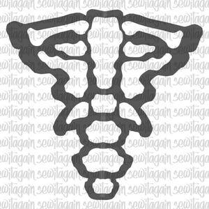 May include: A dark gray die cut in a symmetrical, abstract design. The shape resembles a stylized butterfly or a decorative element, perfect for crafting or scrapbooking projects. The design is repeated on a white background.
