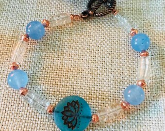 Aids in good luck- helps with friendships- peace- wisdom~~Lotus flower : blue jade, crackle glass, real copper