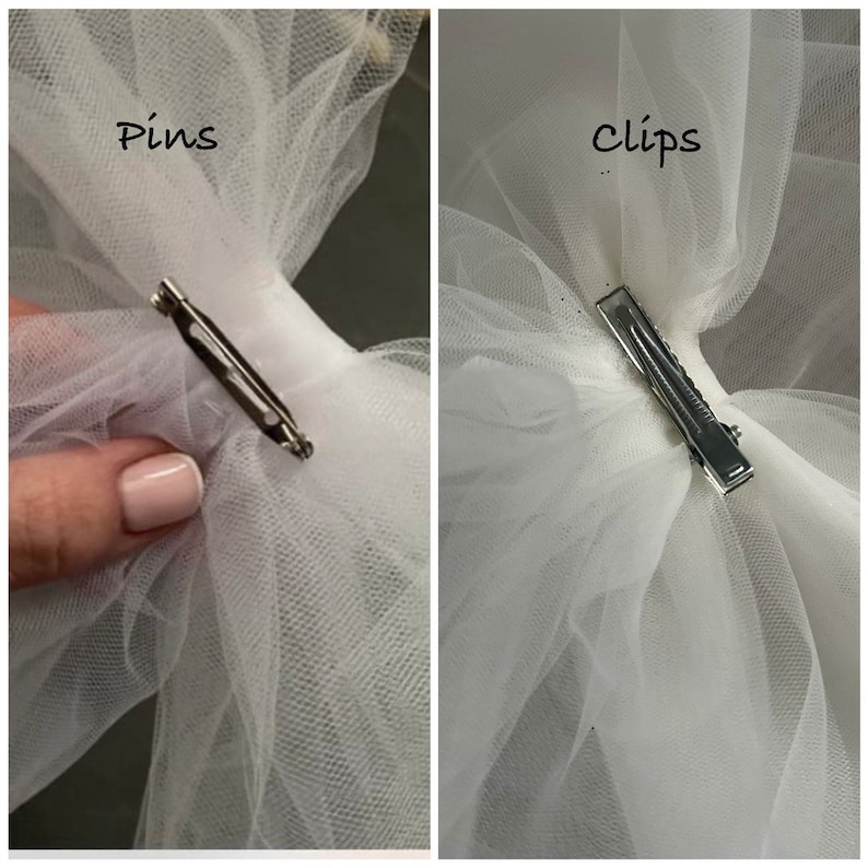 May include: Two images showing two different ways to attach a tulle bow to a fabric item. The first image shows a safety pin attached to the tulle bow. The second image shows a clip attached to the tulle bow. The text "Pins" is above the first image and the text "Clips" is above the second image.