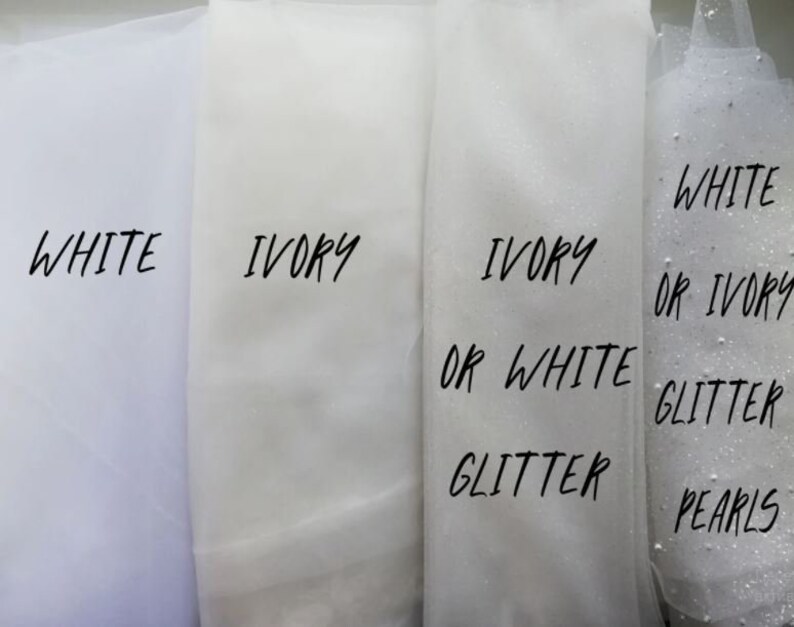 May include: Four swatches of tulle fabric in white and ivory. The swatches are labeled with the colors and options for glitter or pearls.