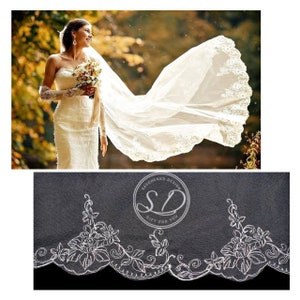 Peut inclure: Un voile de mariée blanc avec un bord festonné et une bordure en dentelle florale. Le voile est fait de tulle doux et a un aspect délicat et romantique.
