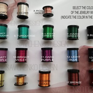 May include: Eighteen spools of jewelry wire in various colors, including ivory, silver, rose gold, turquoise, green, black, purple, violet, blue, bronze, and red. The spools are labeled with numbers 1 through 18. The text "SELECT THE COLOR OF THE JEWELRY WIRE (INDICATE THE COLOR IN THE COMMENTS)" is at the top of the image.