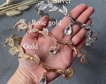 May include: Three leaf-shaped headbands with crystal accents in silver, rose gold, and gold.