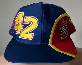 May include: A blue baseball cap with a yellow number 42 on the front and a red and yellow Bud Light Racing logo on the side.