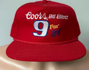May include: Red baseball cap with white embroidered text "Coors Bill Elliott 9 For 87".
