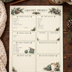 May include: A cream-colored crochet project planner sheet featuring sections for project details, yarn information, hook and gauge, progress tracking, notes, and sketches, decorated with illustrations of pine branches and pinecones.