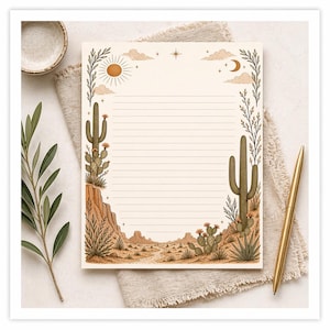 May include: A lined notepad with a desert landscape design. The notepad features a sun, clouds, cacti, and a desert scene. A gold pen rests on the right side. The notepad is on a beige cloth.