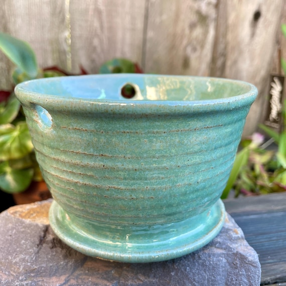 Ceramic aqua color hanging planter - Has attached saucer, with holes for drainage and hanging - Nice addition to home and patio