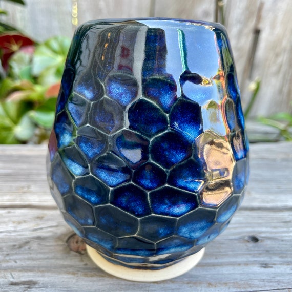 Hand-built faceted ceramic vase with a midnight-to-cloud blue interior — the geometric facets catch light in a way no mass-produced piece can replicate.
