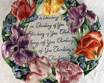 May include: A white ceramic plate with a floral design featuring tulips and irises in shades of purple, pink, yellow, and orange. The plate has a blue and green leafy border and a handwritten message that reads "You Thinking of You Thinking of You Thinking of You Thinking of You Thinking of You Thinking".