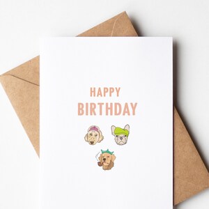 May include: A white card with the text "Happy Birthday" in pink lettering. Three cartoon dogs are pictured wearing party hats.