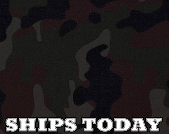 May include: Camouflage fabric with a dark green, brown, and black color scheme. The fabric has a textured surface and the text "SHIPS TODAY" is printed in white letters.