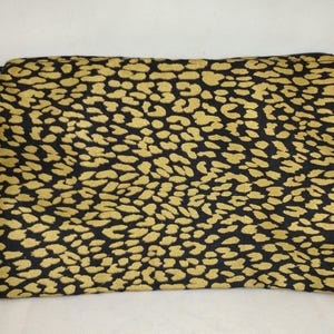 May include: A black zippered pouch with a gold leopard print pattern.
