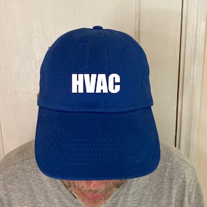 May include: A royal blue baseball cap with the word "HVAC" in white lettering on the front.