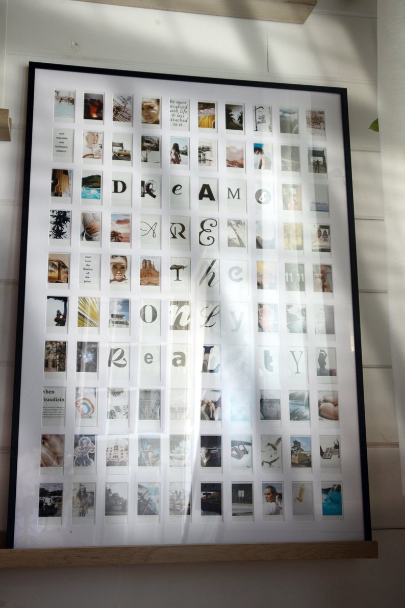 May include: A black framed photo collage with a white background and 64 individual photo spaces. The photos are arranged in a grid pattern and feature a variety of images, including landscapes, portraits, and abstract designs. The words "DREAM ONLY REALITY" are spelled out in the center of the collage using the photos.