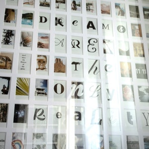 May include: A white picture frame with a black border, containing a collage of photos and text. The text reads "DREAM THE ONLY REALITY".